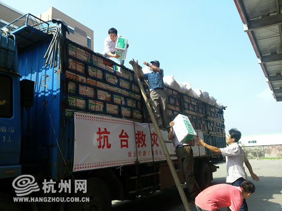 出发前，工人们正抓紧将最后一批物资运送上车。